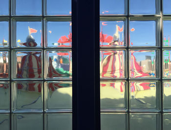 Amusement park ride seen through glass window