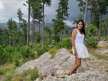 Portrait of young woman standing in forest