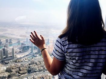 Rear view of woman looking at cityscape