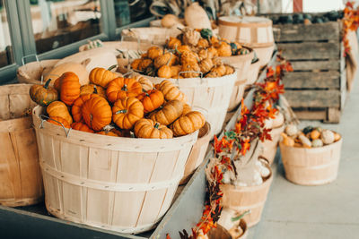  pumpkins in baskets by store on farm. autumn fall harvest. thanksgiving and halloween holiday 