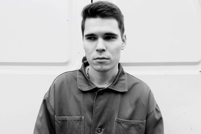 Portrait of man standing against wall