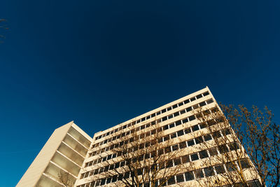 Low angle view of buildings against clear blue sky