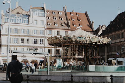 Carousel against buildings in city