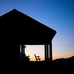 Low angle view of silhouette building against clear sky