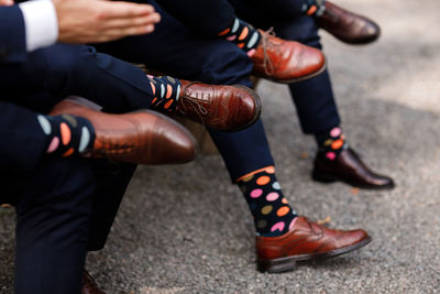 Stylish men's socks. stylish suitcase, men's legs, multicolored socks and new shoes. 