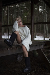 Portrait of young woman sitting on bench