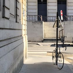 Bicycle parked on street by building