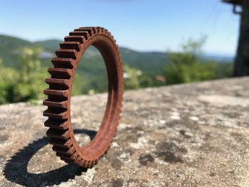 Close-up of rusty wheel on road