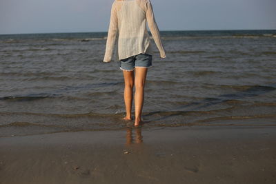 Full length of woman standing on beach