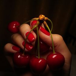 Close-up of hand holding strawberries
