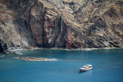 Sailboat on rock by sea