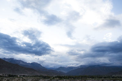 Scenic view of landscape and mountains against sky