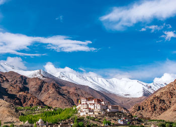 Scenic view of snowcapped mountains against blue sky