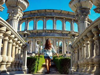 Woman standing in front of historical building