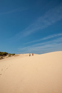 Scenic view of desert against blue sky