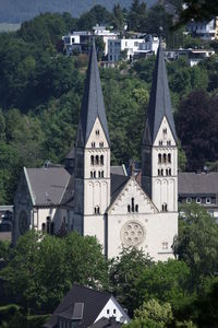 Church amidst trees and buildings in city