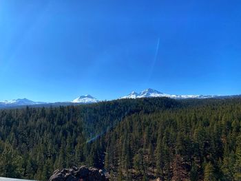 Scenic view of mountains against blue sky