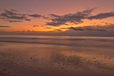 Scenic view of beach against sky during sunset