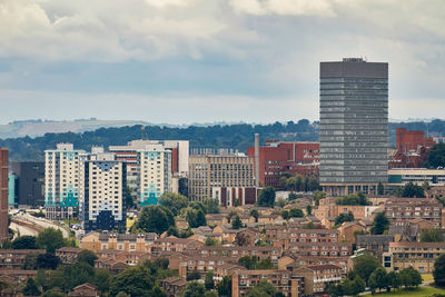 Modern buildings in city against sky