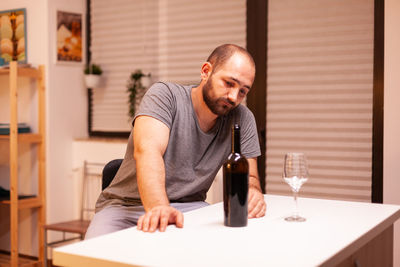 Side view of young man using mobile phone in cafe