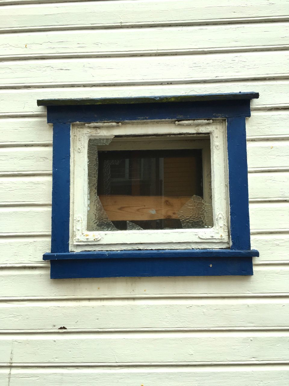 CLOSE-UP OF WINDOW ON OLD BUILDING