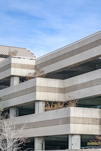 Low angle view of modern building against blue sky