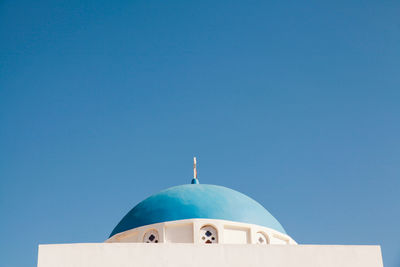 Low angle view of church at santorini against clear sky