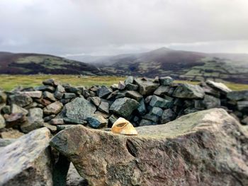 Rocks on mountain against sky