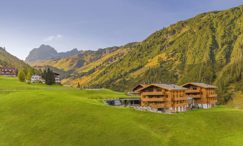 Scenic view of green landscape and mountains against sky