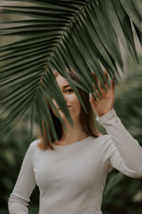 Midsection of woman standing by leaves