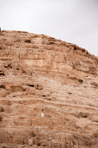 Low angle view of rock formation in desert against sky