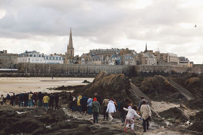 People on landscape against buildings