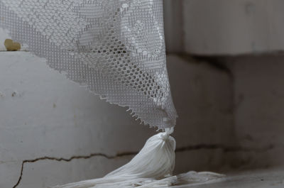 Close-up of wedding dress against wall
