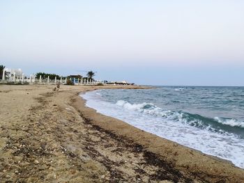 Scenic view of beach against clear sky