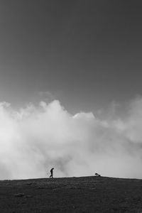 Man standing on land against sky