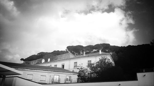 Buildings against cloudy sky