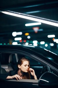 Portrait of young woman in car