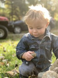 Portrait of cute boy playing in the grass