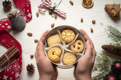 High angle view of hand holding cookies on table