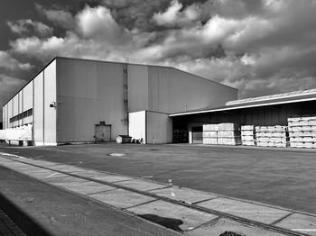 View of factory against cloudy sky