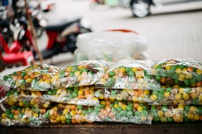 Close-up of colorful food in packets for sale at market stall