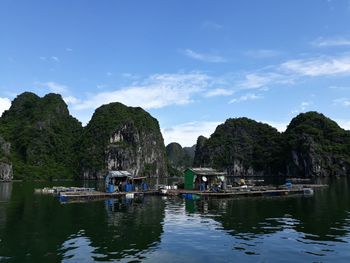 Traditional floating village on emerald waters  amidst a backdrop of limestone karst in ha long bay.