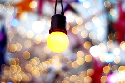 Low angle view of illuminated light bulbs