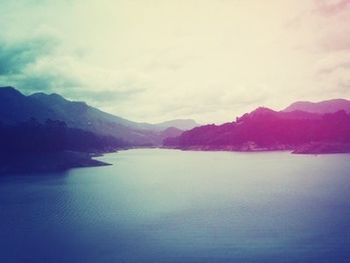 Scenic view of lake against cloudy sky