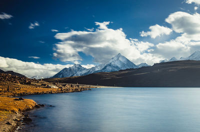 Scenic view of lake and mountains against sky