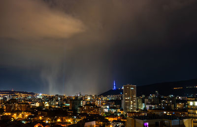 Summer storm with lightning in the night over tbilisi's downtown, georgia
