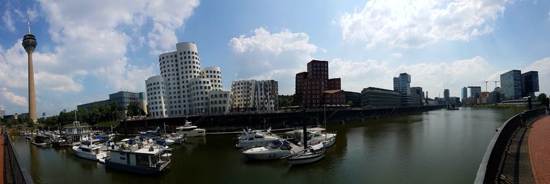 Panoramic view of river and buildings against sky