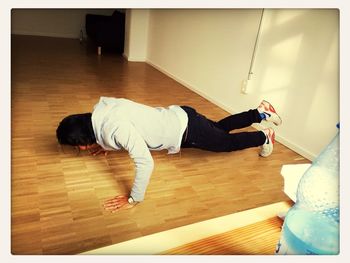 Man lying on hardwood floor