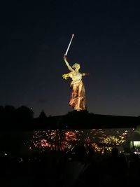 Low angle view of statue against sky at night