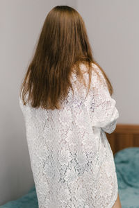 Rear view of woman standing at home